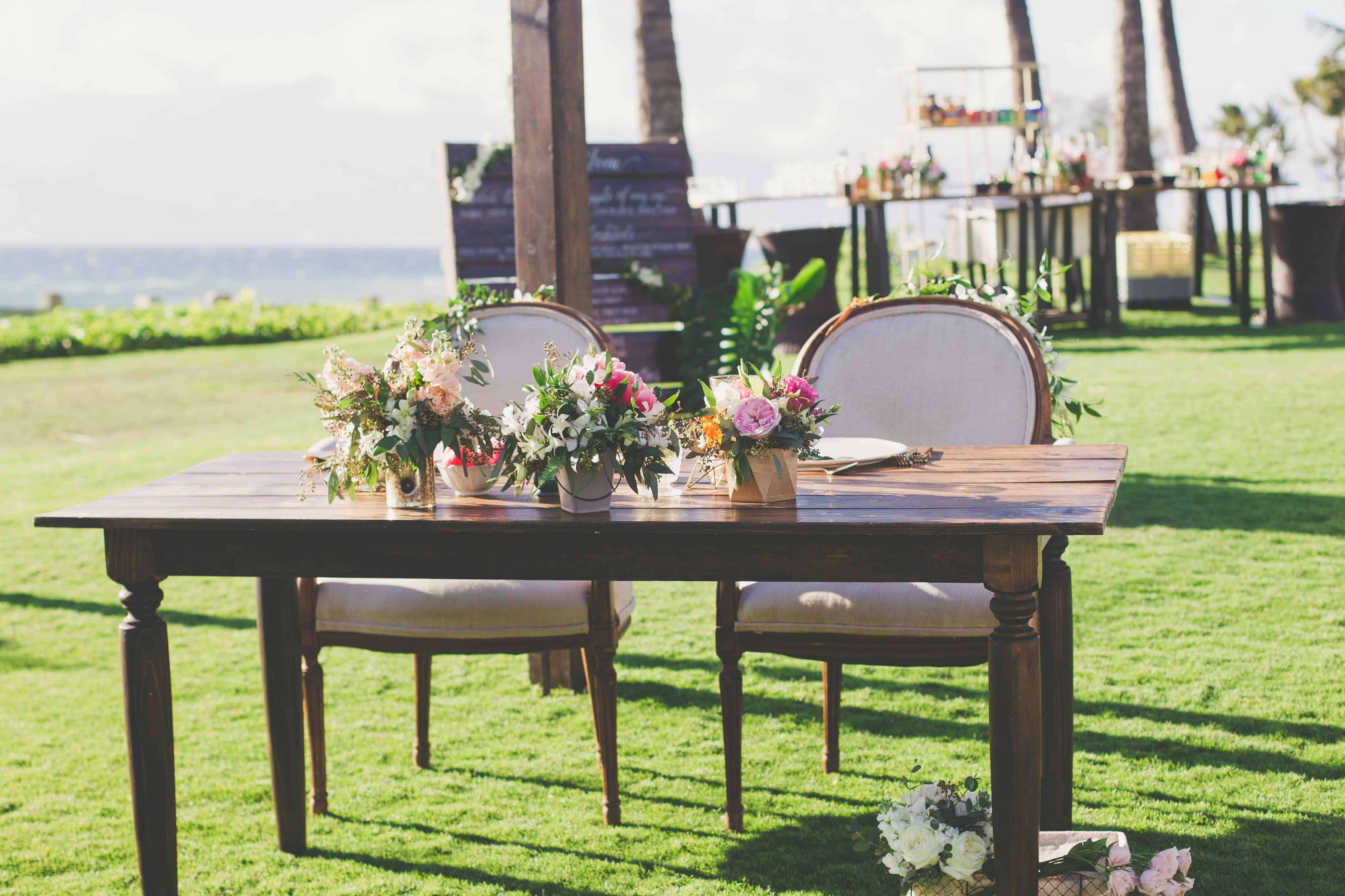 antique table and chairs on lawn for bride and groom