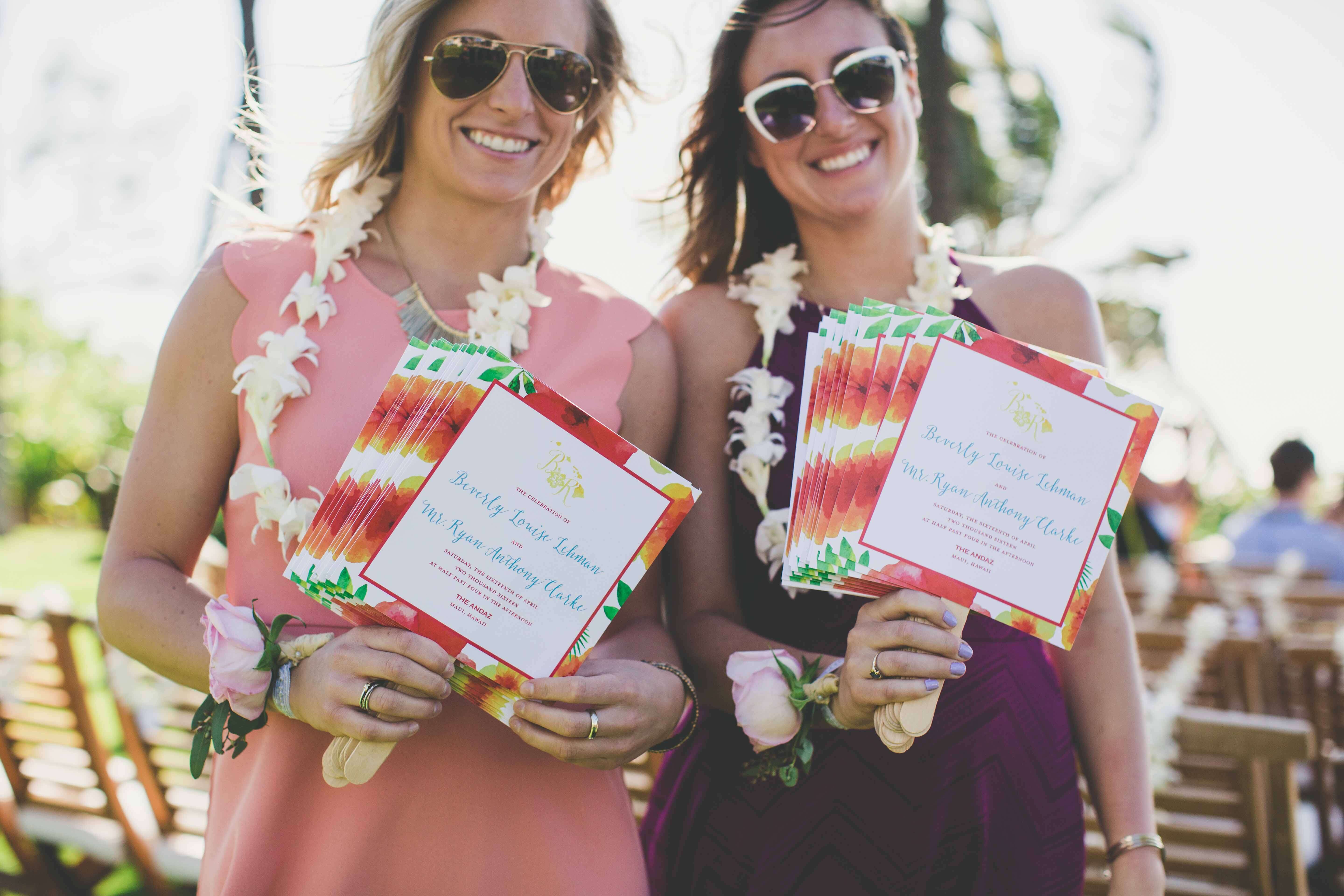 wedding guests holding floral fan wedding programs