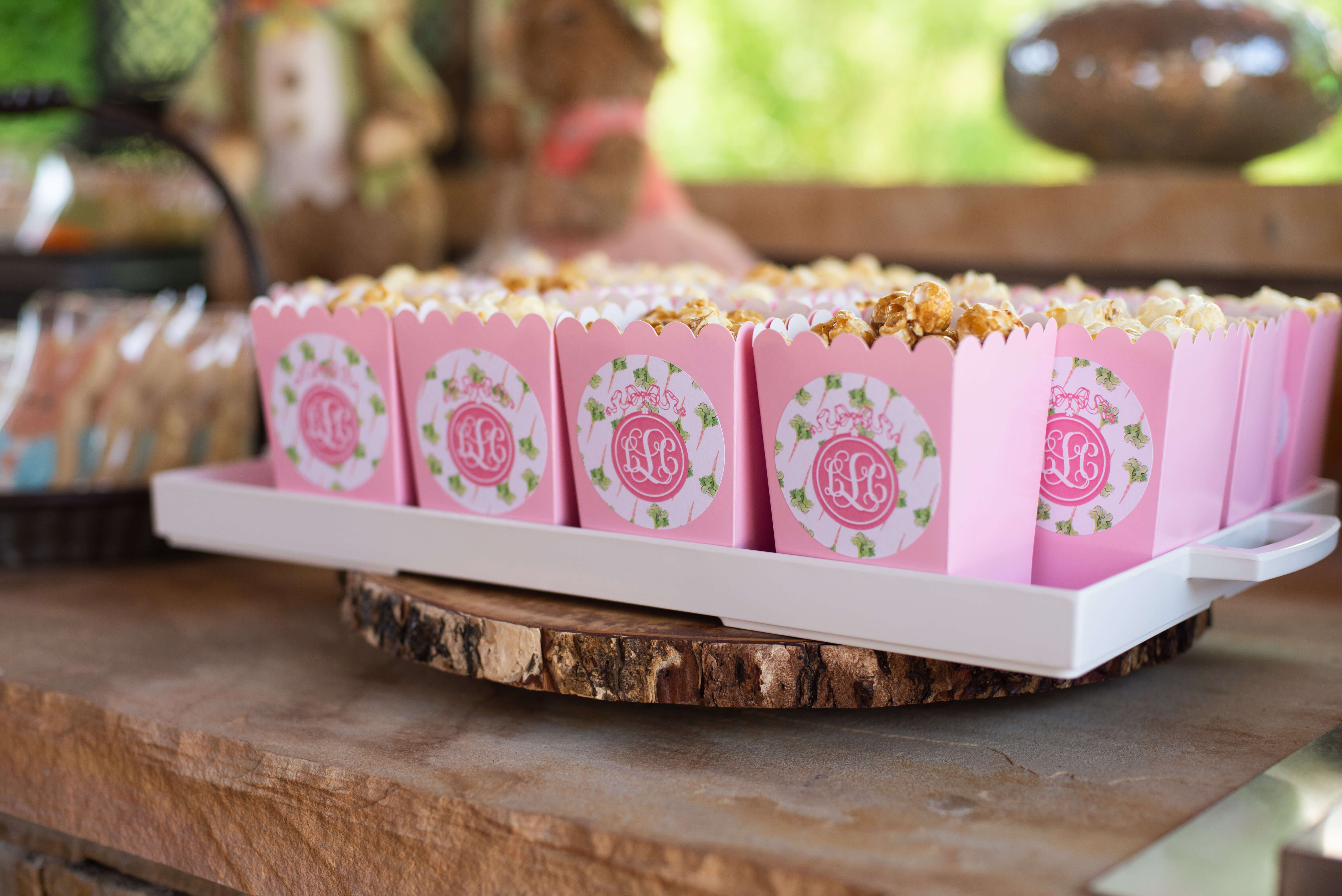 pink favor containers with monogrammed stickers